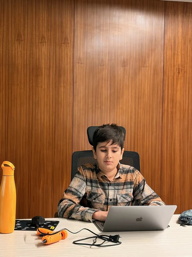 Student working alone on a laptop at a wood-panelled desk